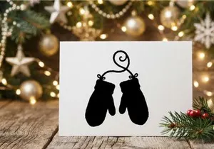 Silhouette of Christmas mittens hanging on a string for holiday decor