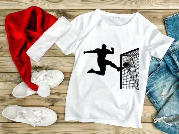 Soccer goalkeeper diving to block a shot on goal in a football match