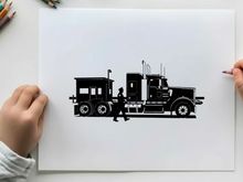 Silhouette of a man walking beside a large truck with trailer