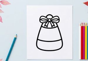 Candy corn icon with a bow. Halloween treat graphic for seasonal holiday design projects.