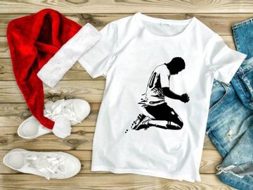 A soccer player kneeling in prayer or supplication on the field preview picture