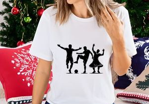 Silhouette of three people playing soccer and dancing together