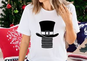 Black top hat with gold clasp on stacked coins isolated