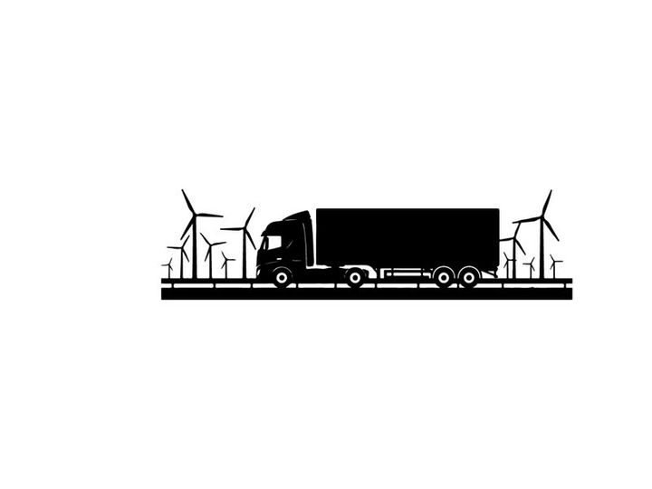 Truck silhouette driving past wind turbines on a sunny day