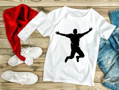 A silhouette of a man jumping in the air with arms outstretched and legs bent