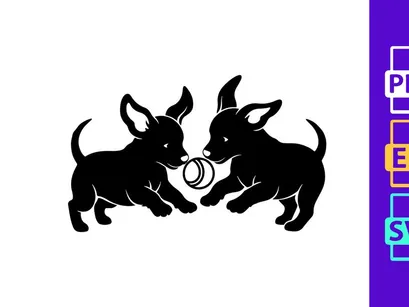 Two black dog puppies playing with metal ring toy silhouette