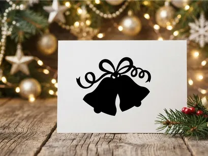 Black silhouette of Christmas bells with a decorative bow isolated on white background