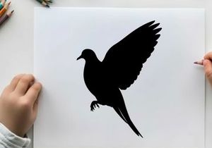 Silhouette of a bird in flight with wings spread wide