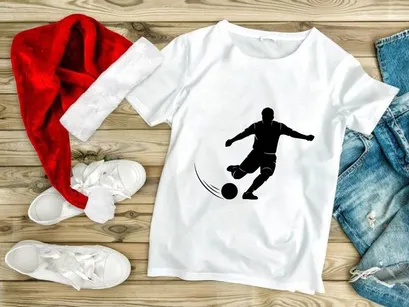 Soccer player kicking a ball in motion silhouette