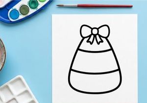 Candy corn icon with a bow. Simple Halloween treat graphic for holiday design projects.