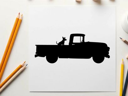 Silhouette of a dog sitting in the back of a vintage pickup truck