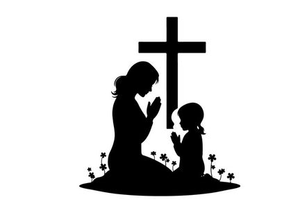 Silhouette of mother and child praying by cross