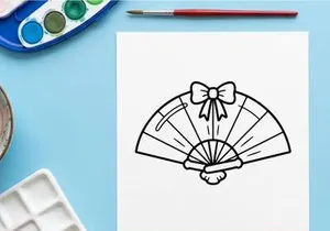 Hand-drawn Halloween paper fan with black bow. Vintage-style decorative folding fan featuring a spooky bow tie design.