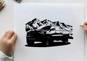 Silhouette of a pickup truck in front of snowy mountains