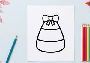 Candy corn icon with a bow. Simple Halloween treat graphic for holiday design projects.