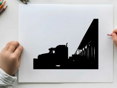 Truck silhouette parked beside a building at sunset