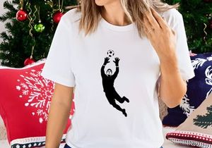 Soccer goalkeeper in action diving to catch a ball in mid air