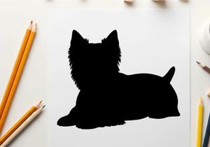 Silhouette of a small black dog lying down calmly