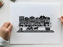 Silhouette of a horse drawn carriage in front of buildings
