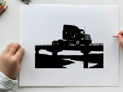 Silhouette of a semi truck driving across a bridge