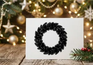 Black Christmas wreath silhouette isolated on white background for holiday design projects.
