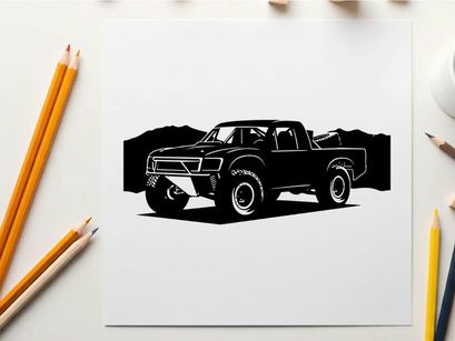 Silhouette of a pickup truck in front of mountains