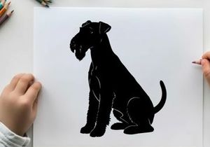 Silhouette of a sitting dog with floppy ears and tail