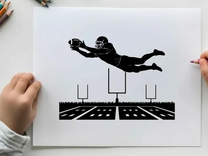 American football player in mid air silhouette catching a ball