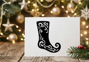 Silhouet stoking Natal hitam dengan pola swirl bunga dekoratif pada latar belakang putih