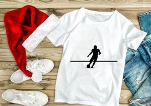 Silhouette of a soccer player kicking a ball in motion