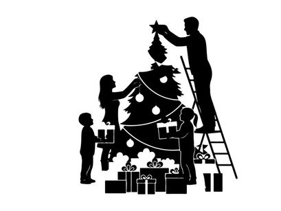 Family decorating christmas tree in silhouette