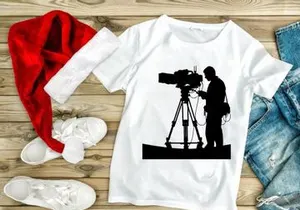 Silhouette of a cameraman operating a large video camera on a tripod stand