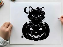 Black cat silhouette sitting on a jack o lantern