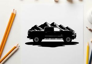 Silhouette of a pickup truck in front of mountains