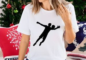 A silhouette of a person playing handball in mid air with outstretched arms and legs