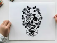Silhouette of a skull with roses and roots