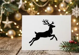 Black silhouette of a jumping reindeer isolated on a white background for Christmas design