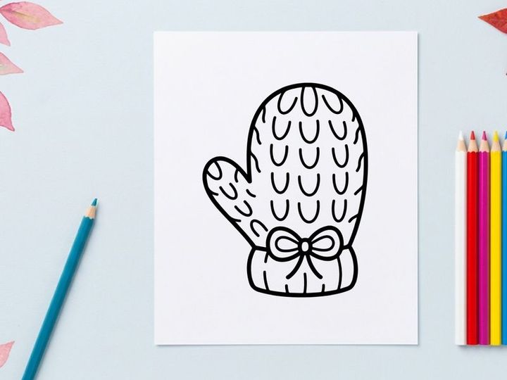 Hand-drawn Halloween mitten with ghost pattern and ribbon bow. Spooky knitted glove illustration for festive fall and winter designs.