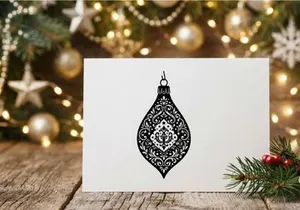 Black and white Christmas ornament with intricate damask pattern isolated on white background