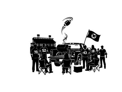 Silhouette of people gathered around a truck with a flag and building