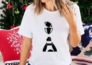 A person holding a trophy with a football on top in black and white