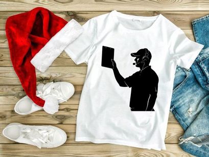 A silhouette of a man in a baseball cap holding a tablet and wearing a headset