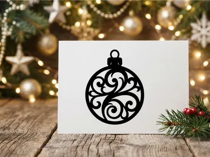 Black Christmas bauble silhouette with ornate floral filigree pattern on white background