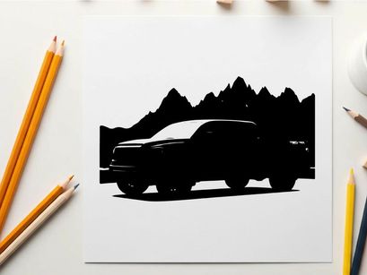 Silhouette of a pickup truck in front of mountains