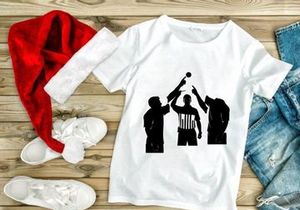 Silhouette of three men playing volleyball with referee