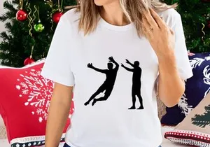 Two black silhouettes of men playing volleyball in mid air and standing