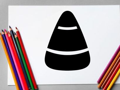 Close-up of a black and white candy corn with colorful stripes