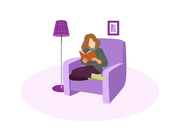 A girl reading book on the chair