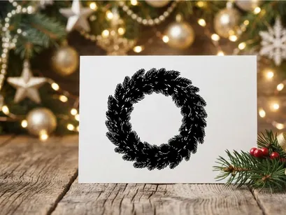 Black Christmas wreath silhouette isolated on white background for holiday design projects.