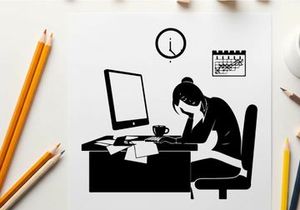 Silhouette of a woman working late at her desk
